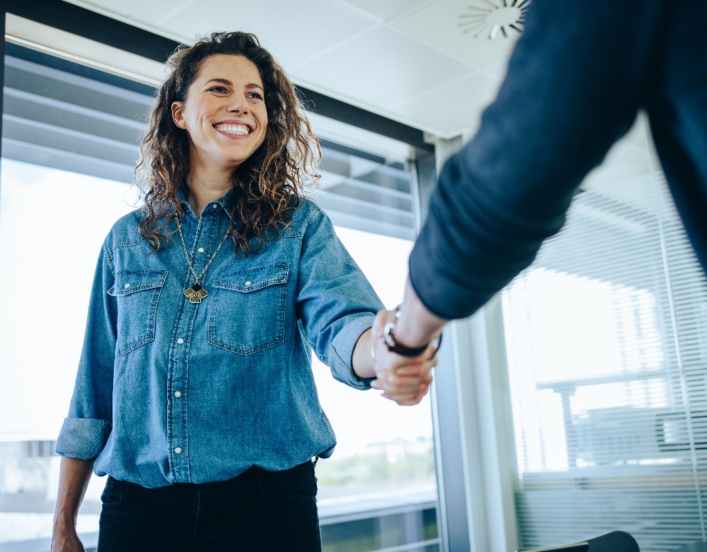 Recruitment manager shaking hand with male candidate