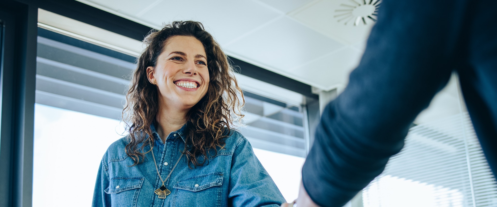 Recruitment manager shaking hand with male candidate